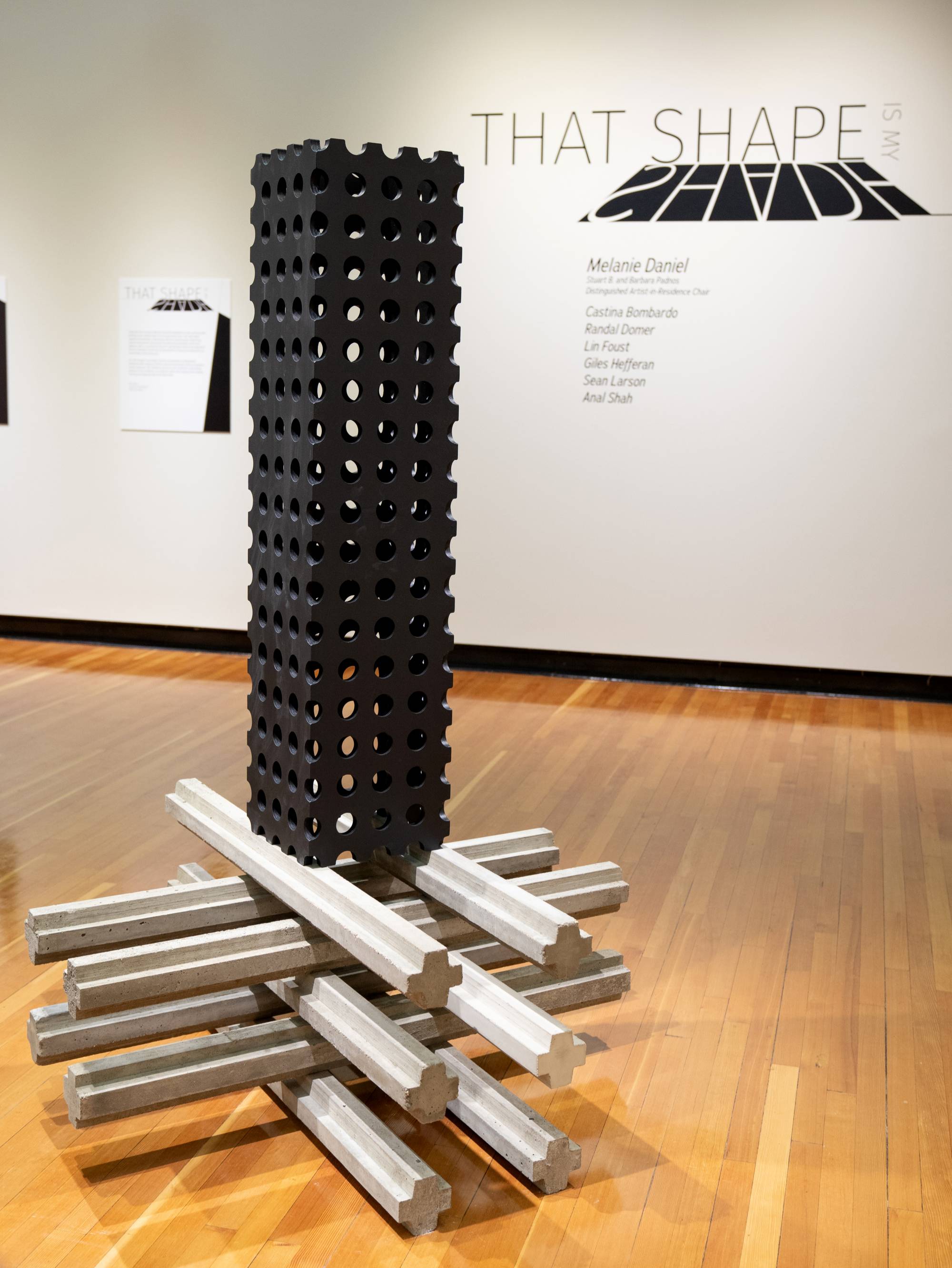 black and white photograph of man's silhouette walking away from viewer in cobblestone alley